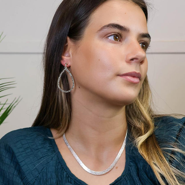 Faux Gold Large Teardrop Drop Earring modelled on ear.